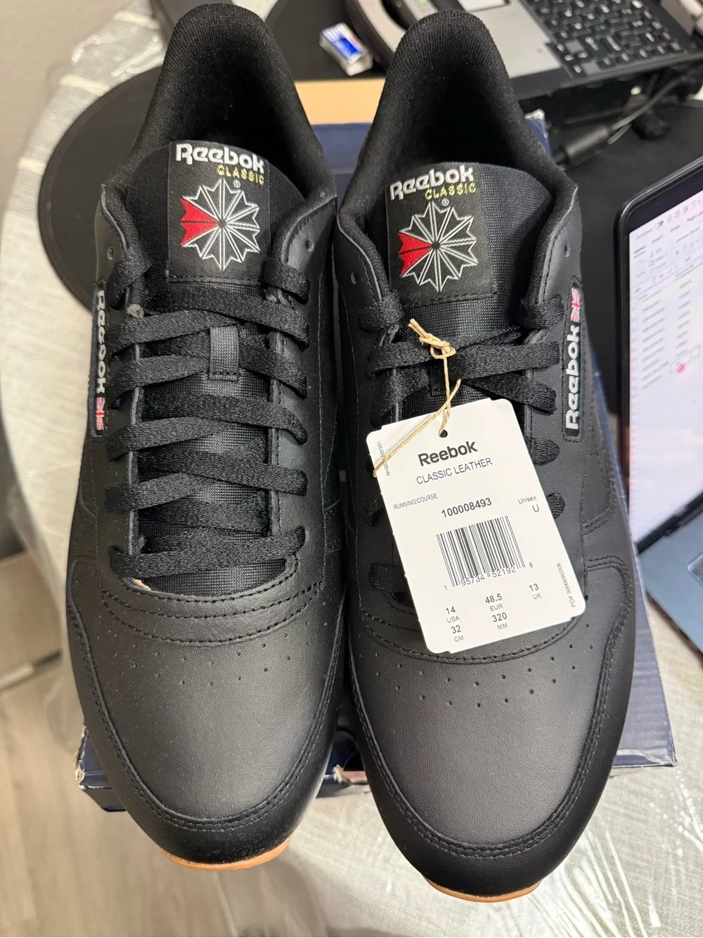 Reebok Classic Leather Men's Black Sneakers with Red Accent is also unisex